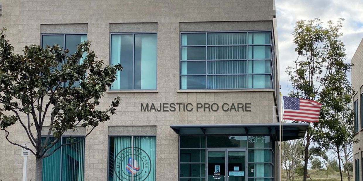 Office building with "Majestic Pro Care" signage and American flag outside. | Commercial Janitorial Services | Office Cleaning Programs | workspace sanitation
