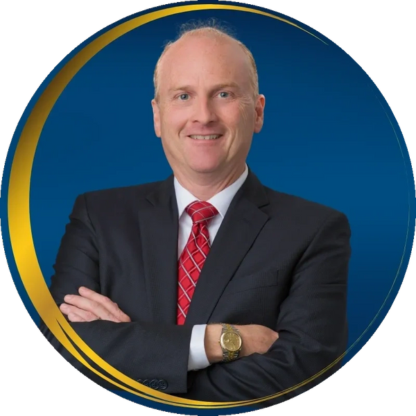 White handsome male 58 yrs old in a blue suit with a red tie crossing arms showing gold Rolex watch