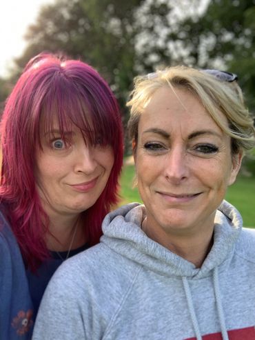 Two ladies (Sarah - left with red hair and Rachel - right with blond hair) smiling into the camera