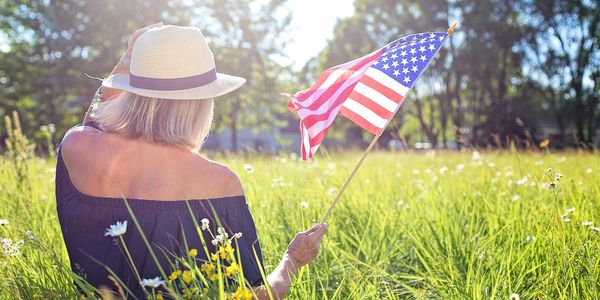 Young woman holding american USA flag.