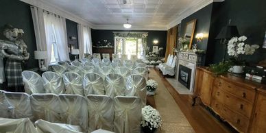 Silk-draped seating, a radiant gold façade layered with white blooms and lush greenery — the perfect