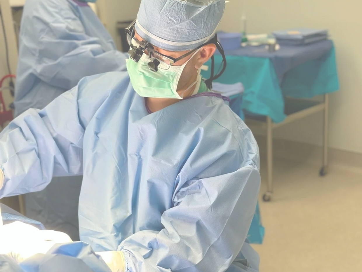 Dr. Jones is operating, performing a mommy makeover, a beautiful demonstration of cosmetic surgery