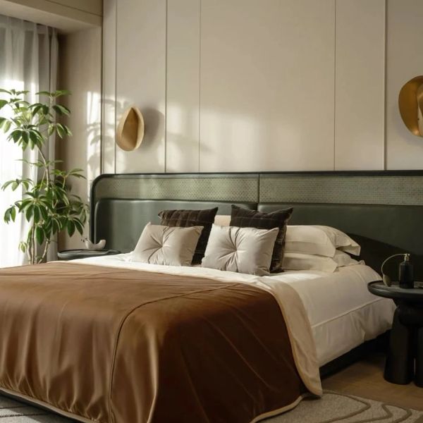 Cozy modern bedroom with green headboard and brown bedspread.