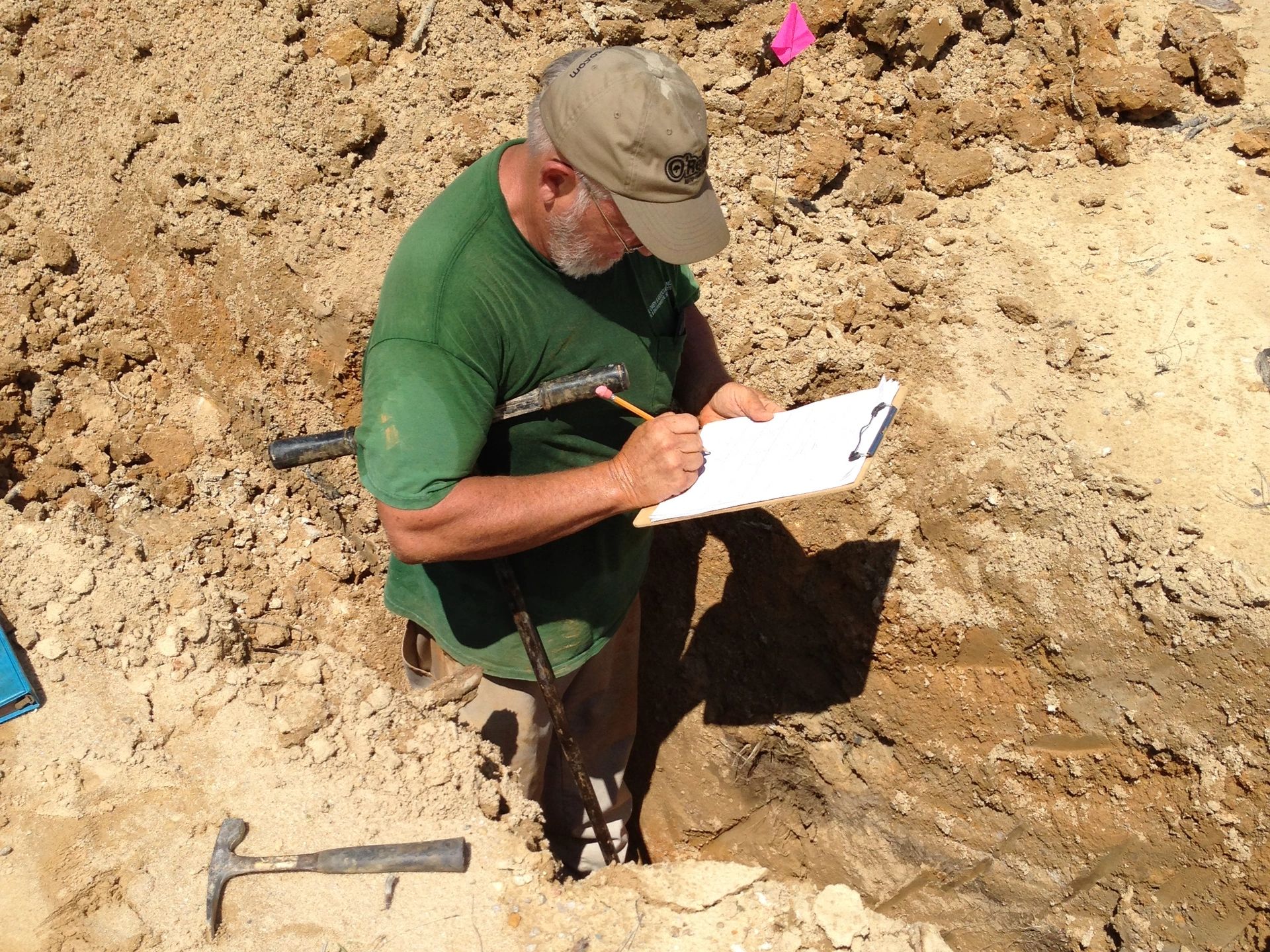 Recording notes on the soil profile in a pit