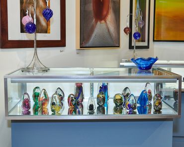 Case of artwork on display at Bedcat Studios at the Glass Menagerie in Corning, New York.