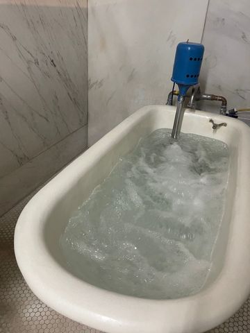 Buckstaff Bathhouse original thermal bath tub, Colorado marble walls and hexagonal floor tile