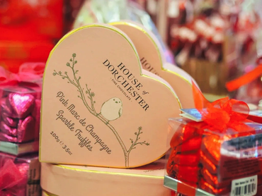 Heart-shaped chocolate box with elegant design and festive packaging.