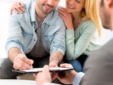 Couple signing a document with a professional.