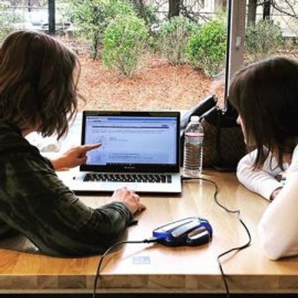 Two people studying together with a laptop.