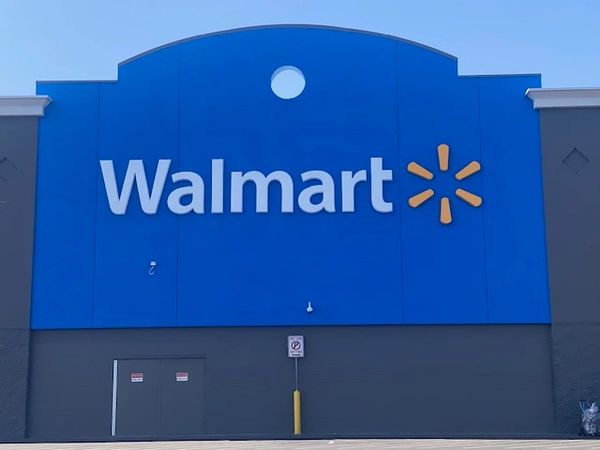 Exterior view of a Walmart store with its logo prominently displayed.