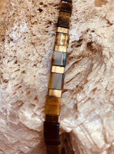 24K gold-plated accents are paired with tiger eye for a refined, powerful, and unisex look.