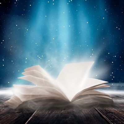 Glowing open book with magical light.