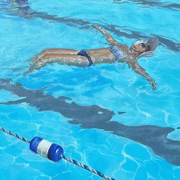 A woman floats peacefully in a blue swimming pool under sunlight.