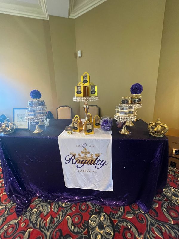 Elegant dessert table with purple and gold theme at Royalty Sweetz LLC.