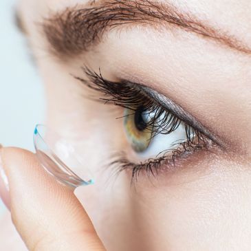 Woman putting in bi-focal contact lenses