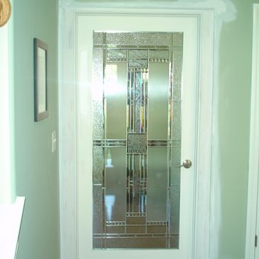 White entry door with square multi-colored stained glass