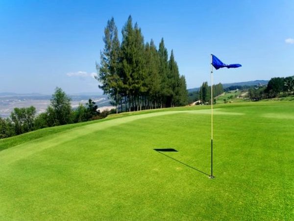 Golf flag on a golf green in Europe. European golf holidays.