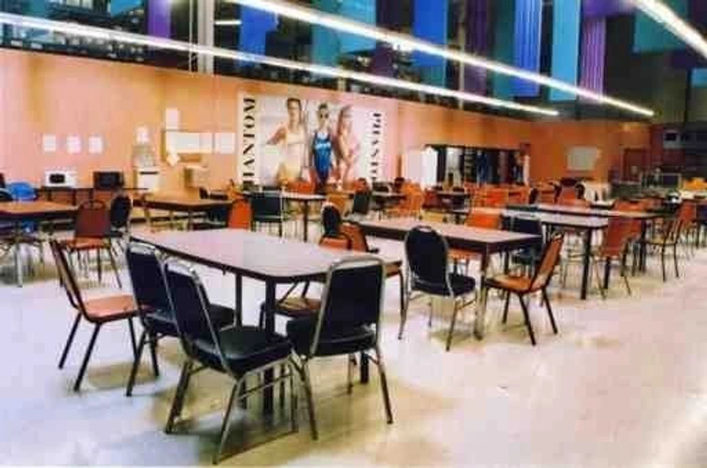 Empty cafeteria with tables and chairs.