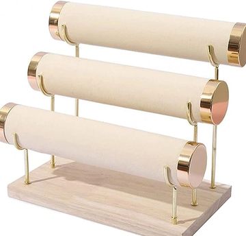Three-tier jewelry display stand with gold accents.