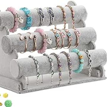 Display of colorful bracelets on a gray velvet stand.