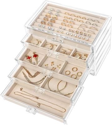 Clear acrylic jewelry organizer with rings, necklaces, and earrings.