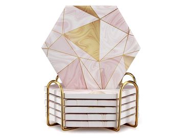 Set of geometric marble coasters with gold holders.