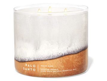 Three-wick Palo Santo scented candle in a glass container.