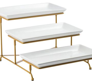 Three-tiered white rectangular serving trays with gold metal frame.