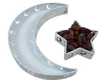 Moon and star-shaped metal trays, one filled with dates.