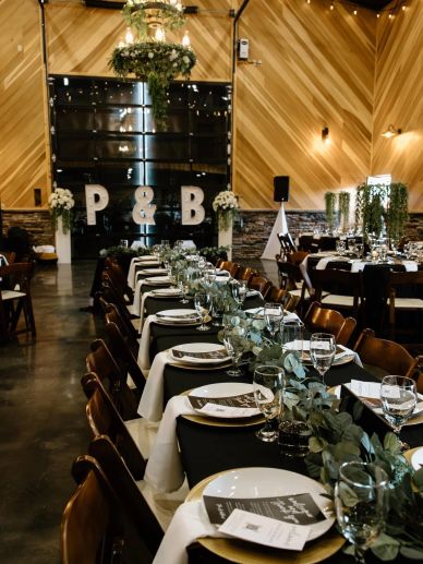 Elegantly decorated wedding reception with a long table and floral centerpiece.