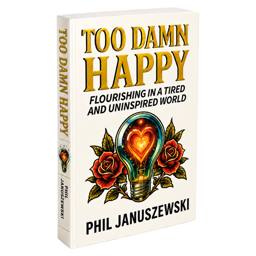 3D paperback mockup of Too Damn Happy by Phil Januszewski showing the front cover and spine.