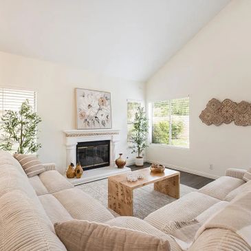 Bright living room with a large beige sectional sofa and fireplace.