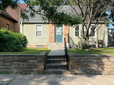 Small house with a blue door and front steps.