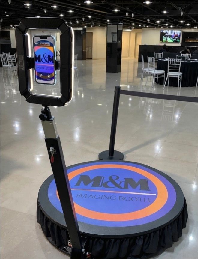 Modern imaging booth setup with a phone holder and illuminated ring light.