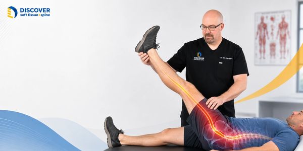 Dr. Lambert evaluating straight leg raise for a patient with recurring sciatic pain in Grand Rapids.