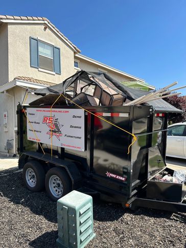 A trailer filled with junk/trash after a quick and successful trash removal run by RS Junk Hauling.