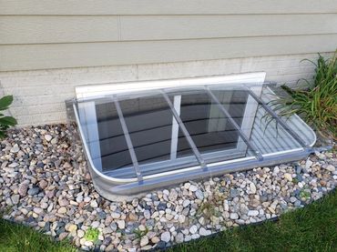A sliding egress window with a heavy duty 300  pound rated cover that allows sunlight and safety