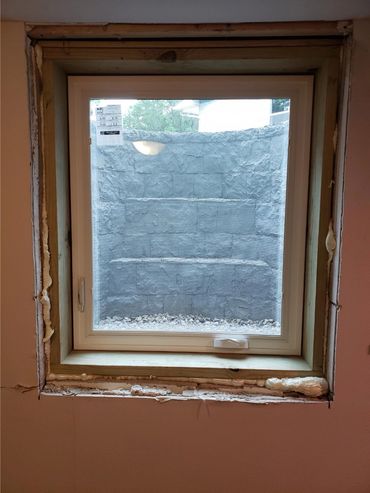A newly-installed window before the interior trim has been installed