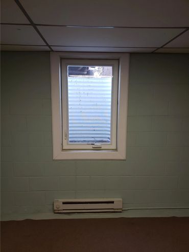 A casement egress window installed on a block wall foundation