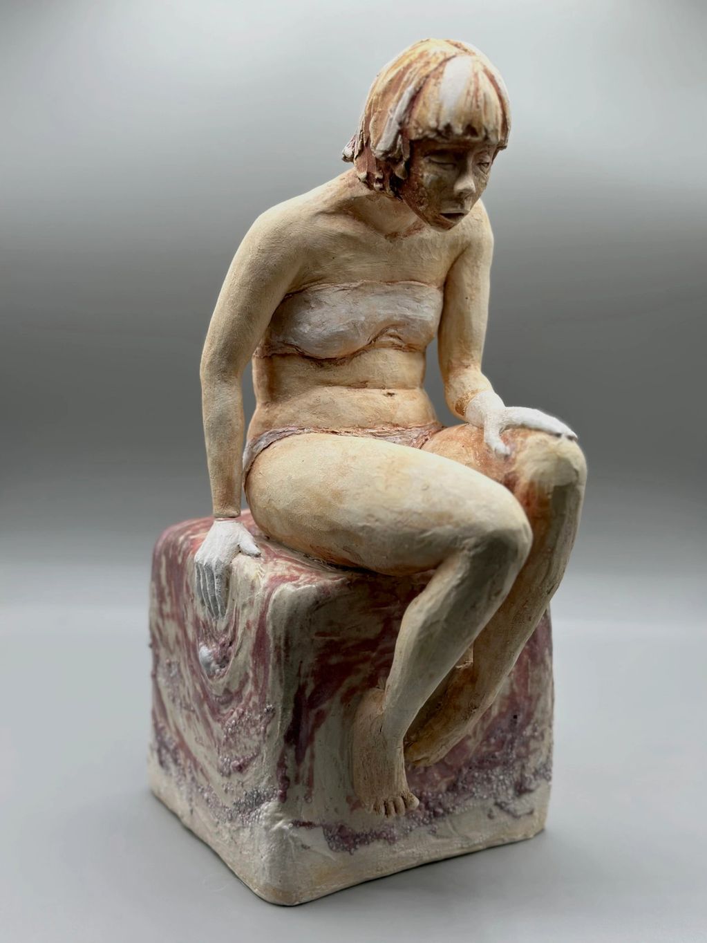 Girl sitting on red square