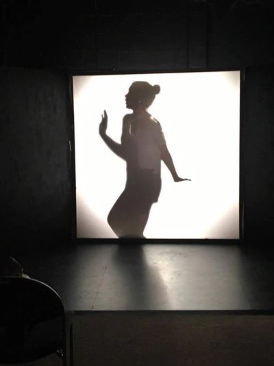 Silhouette of woman on stage