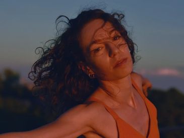 Head shot filmmaker Drew Berry with setting sun behind her.