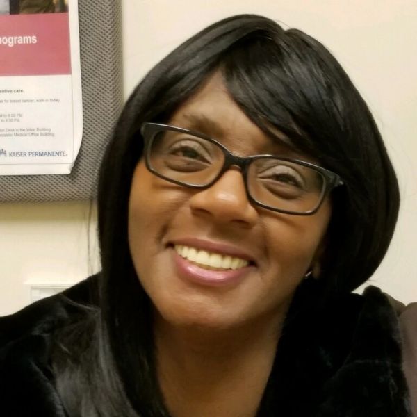 Smiling woman with glasses.
