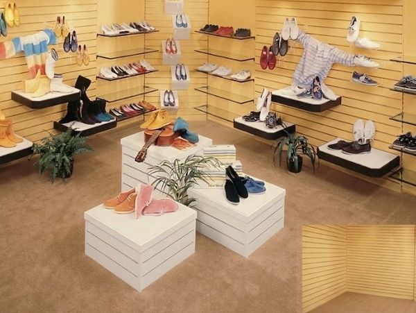 A shoe store interior with various shoes displayed on shelves and platforms.