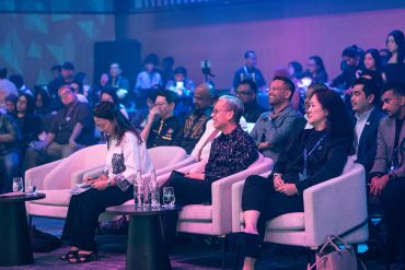Audience attentively watching a presentation in a conference setting.