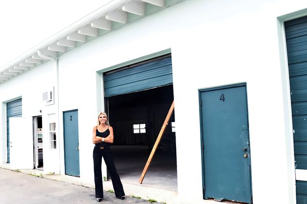 Holly Meyer Lucas standing in front of The Mother Ship, her warehouse in Jupiter, Florida. 
