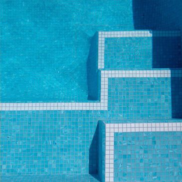 Blue tiled pool stairs with white edges.