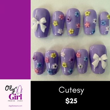 Purple press-on nails with floral designs and white bows.