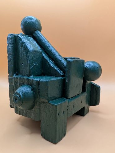 Abstract wooden sculpture painted teal.