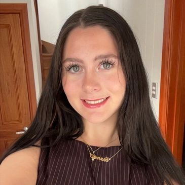 Young woman with long dark hair smiling.